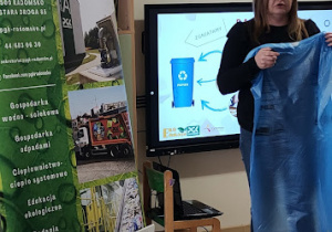 Przedstawicielka PGK-u prowadzi pogawędkę z dziećmi na temat sortowania śmieci.